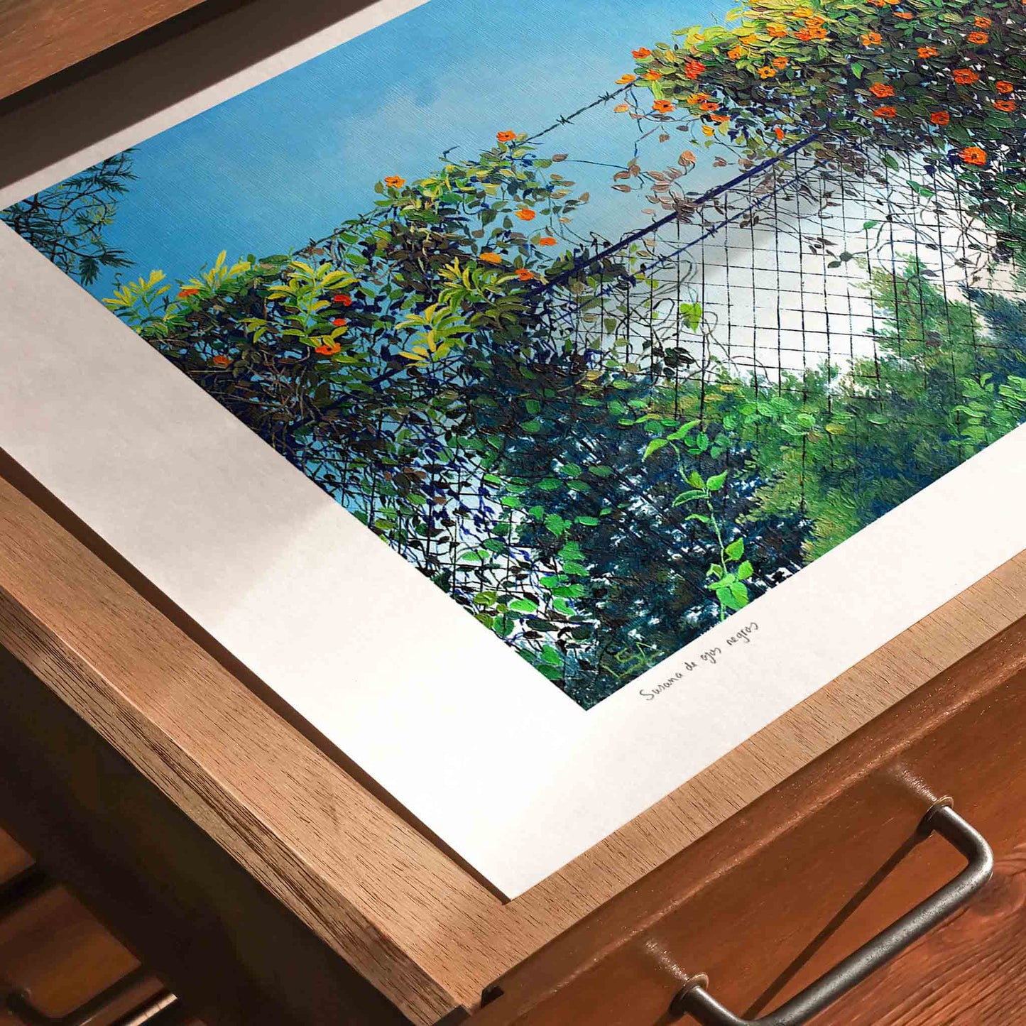 Contemporary wall art of a landscape lying unframed in a draw.
