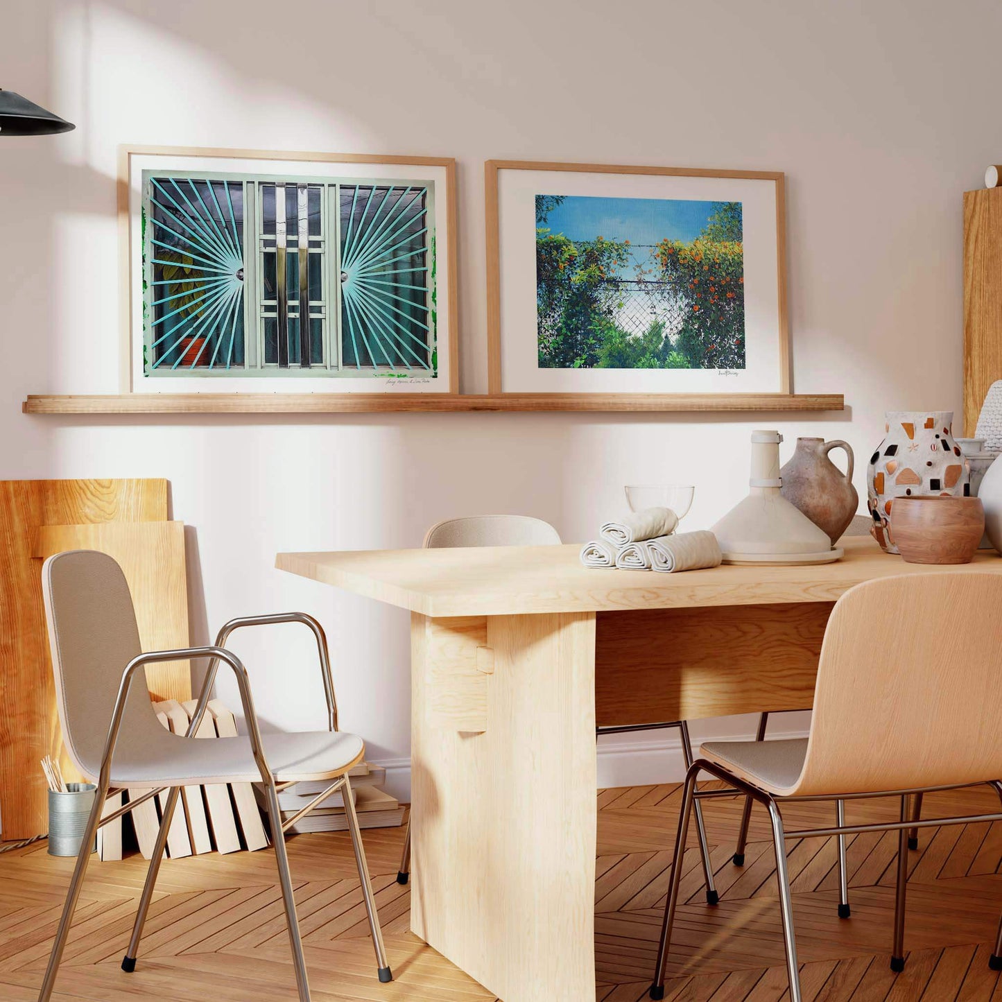 Two contemporary landscape prints displayed on a shelf in a neutral living space.