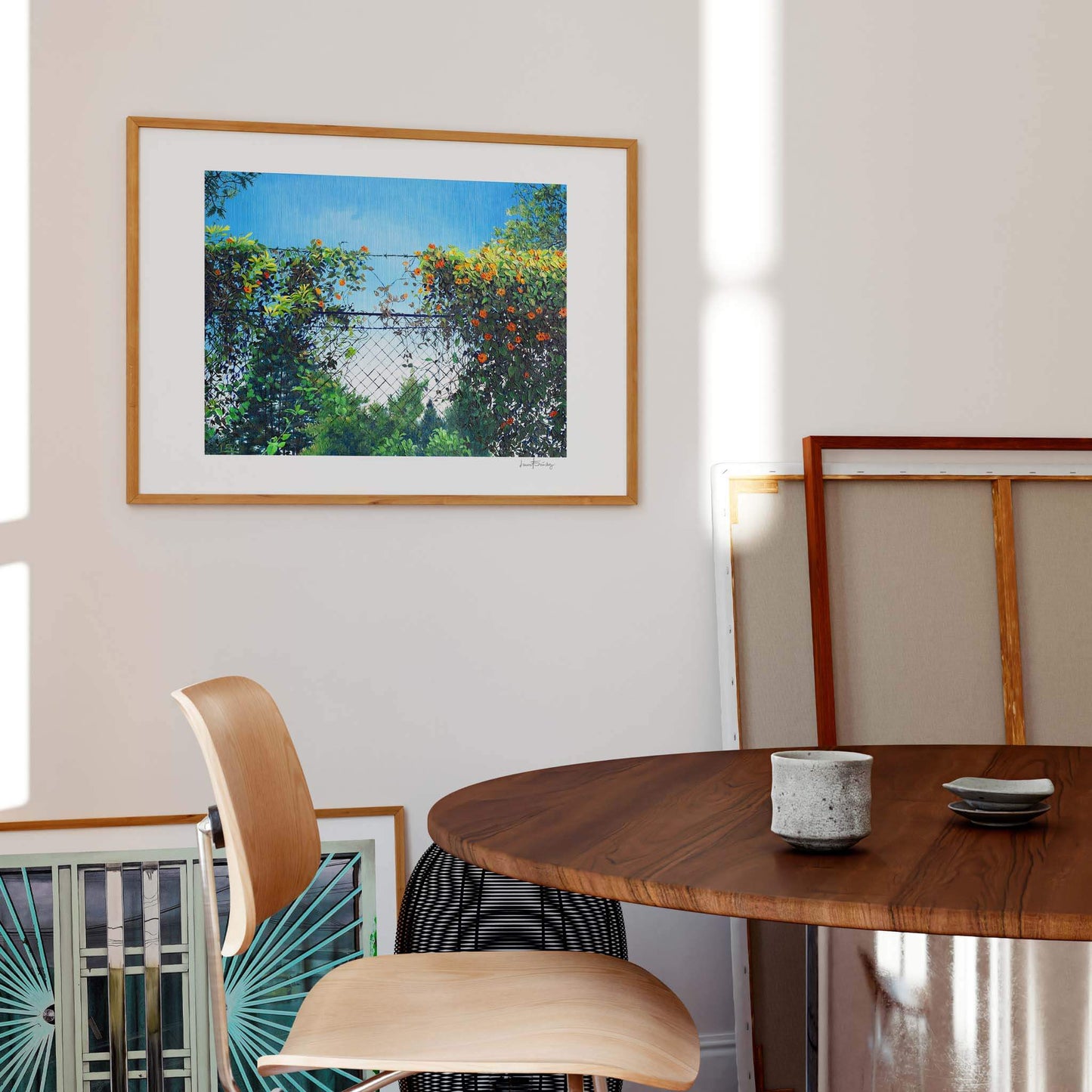 Contemporary wall art of a landscape displayed in a modern dining room.