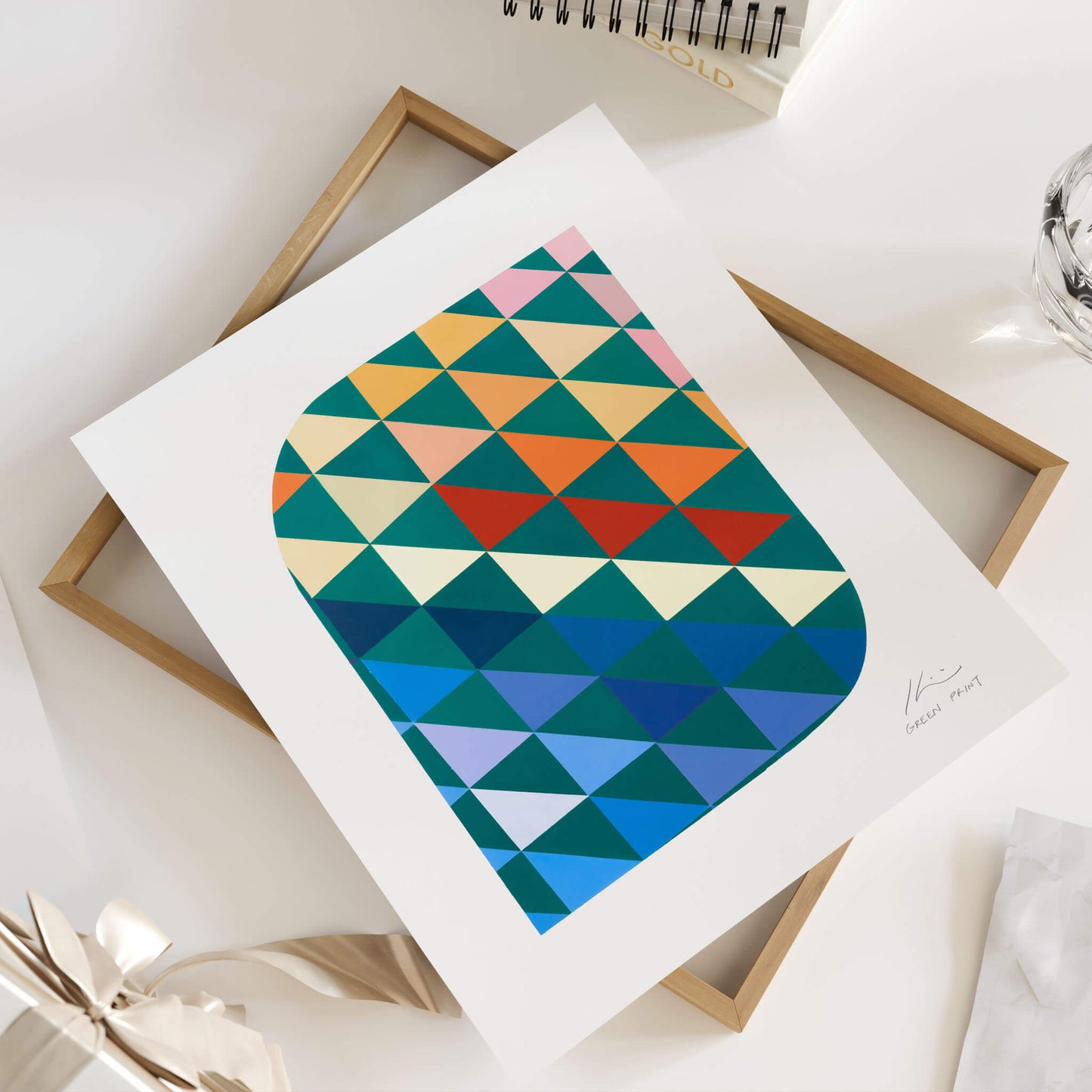 Geometric wall art sitting on top of an oak frame.