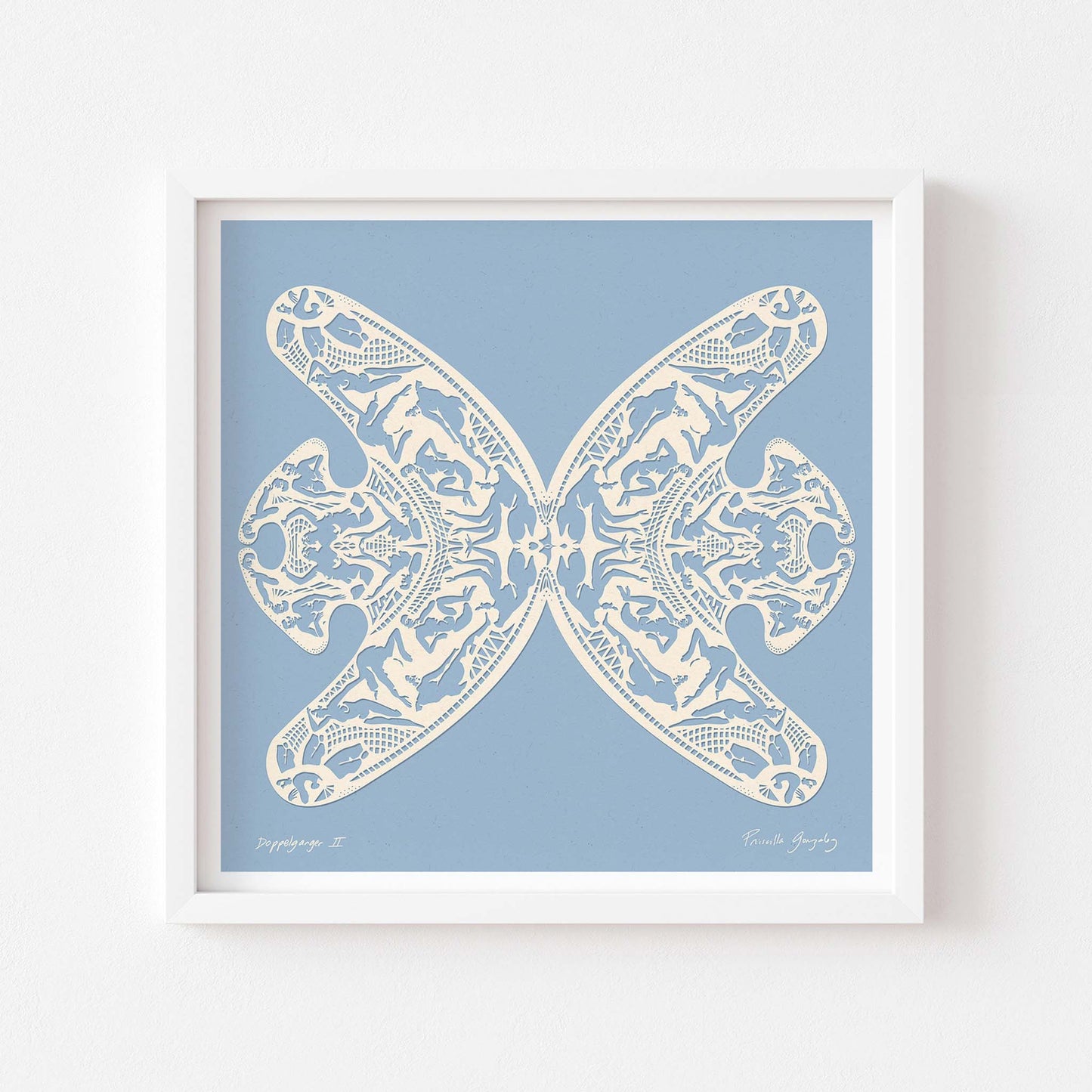Square blue and white paper cut art print framed in white.
