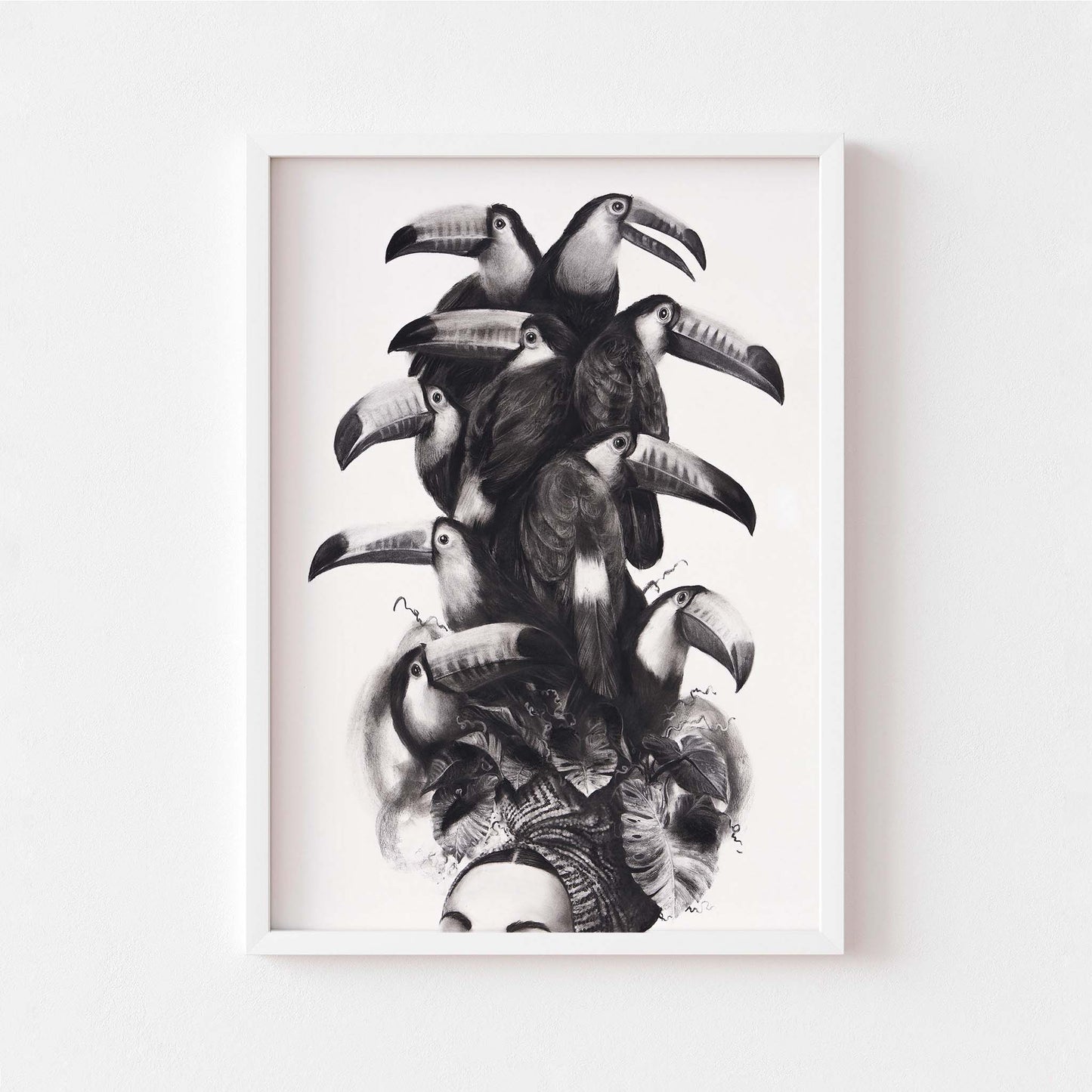 Black and white wall art print of a women wearing a toucan headdress in a white frame.