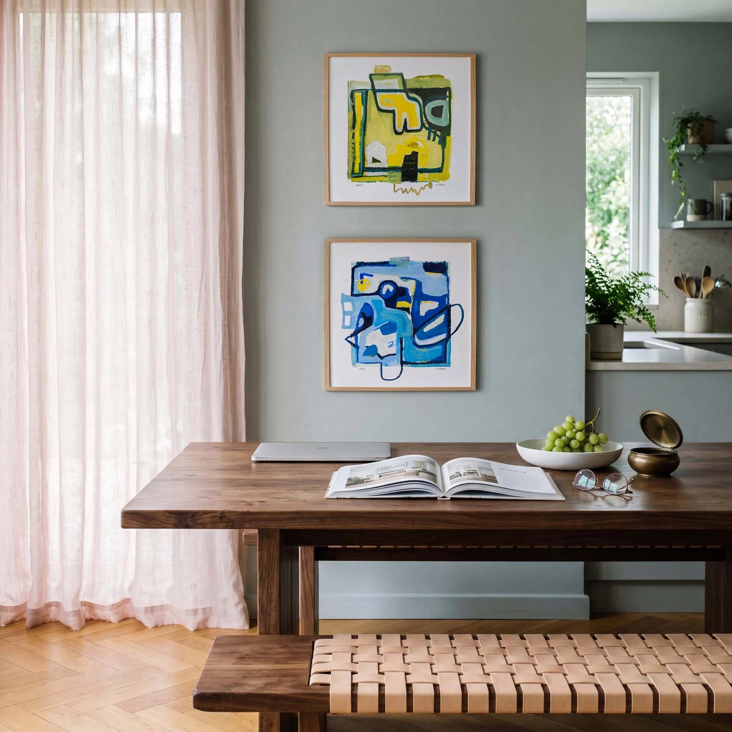 Dining room with wooden table, abstract art on the wall, and a bench.