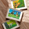 Set of three animal prints framed in oak on wooden living room floor.