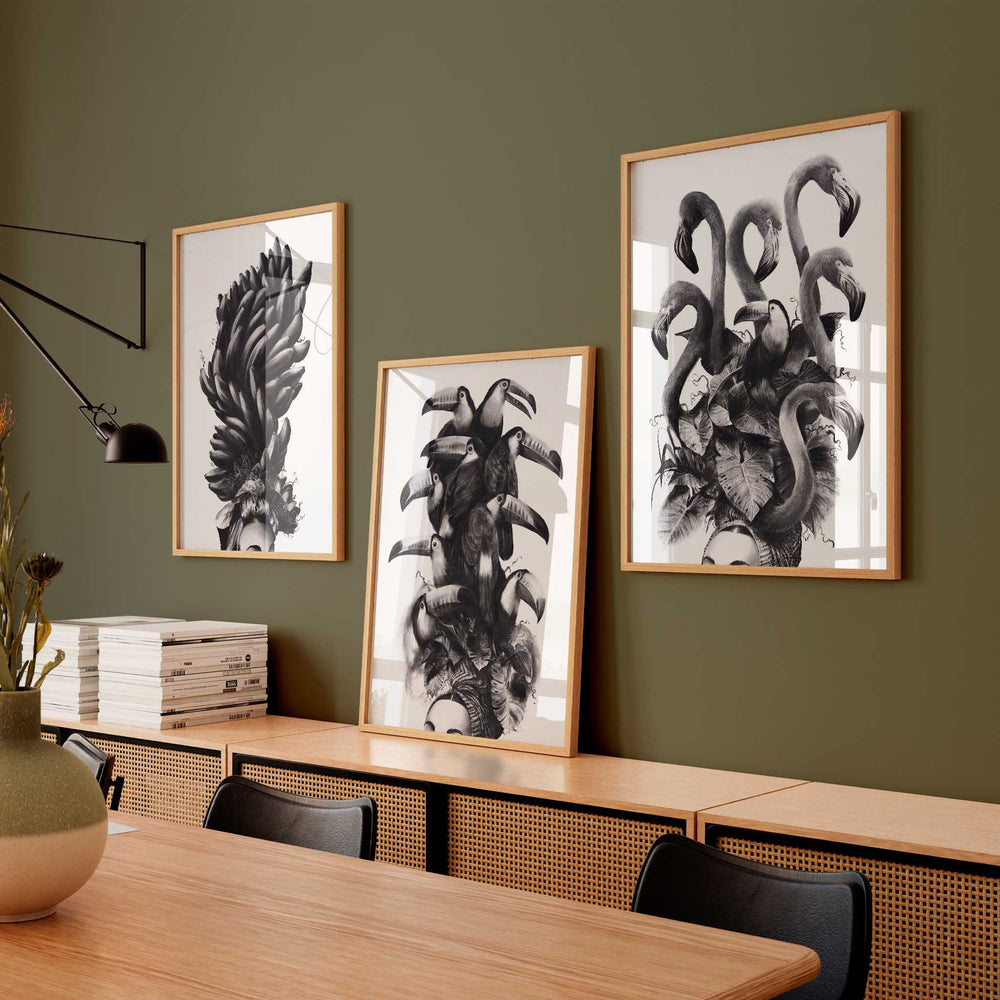 
                  
                    Set of three monochrome wall art prints on a dark green wall in an office.
                  
                