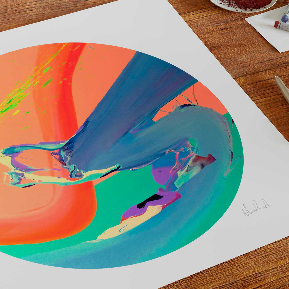 
                  
                    Orange, blue and green unframed art print on a wooden table.
                  
                