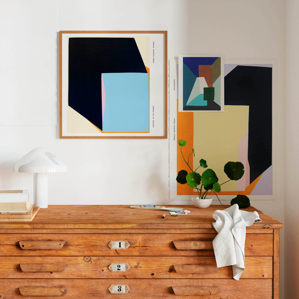 Set of three modern abstract art posters in a contemporary living room.