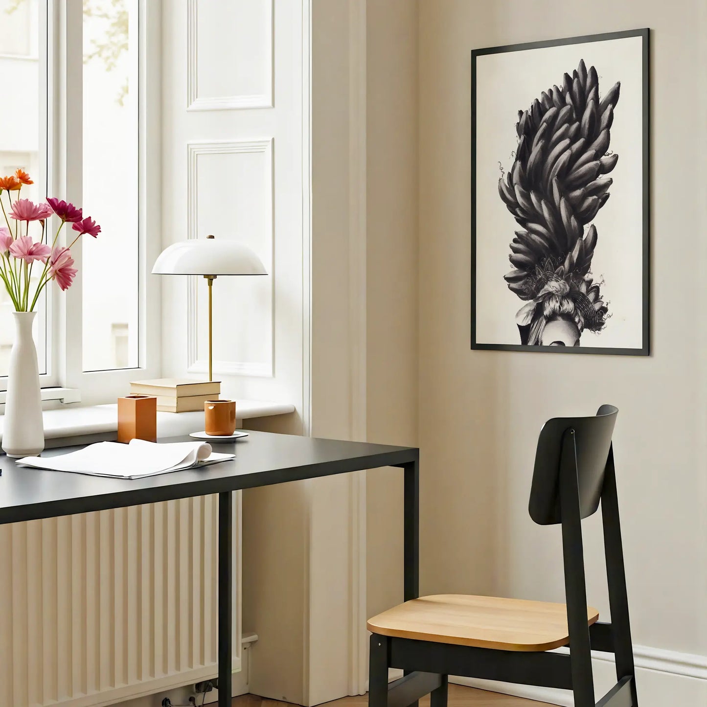Modern interior with a black desk, chair, and monochrome art print.