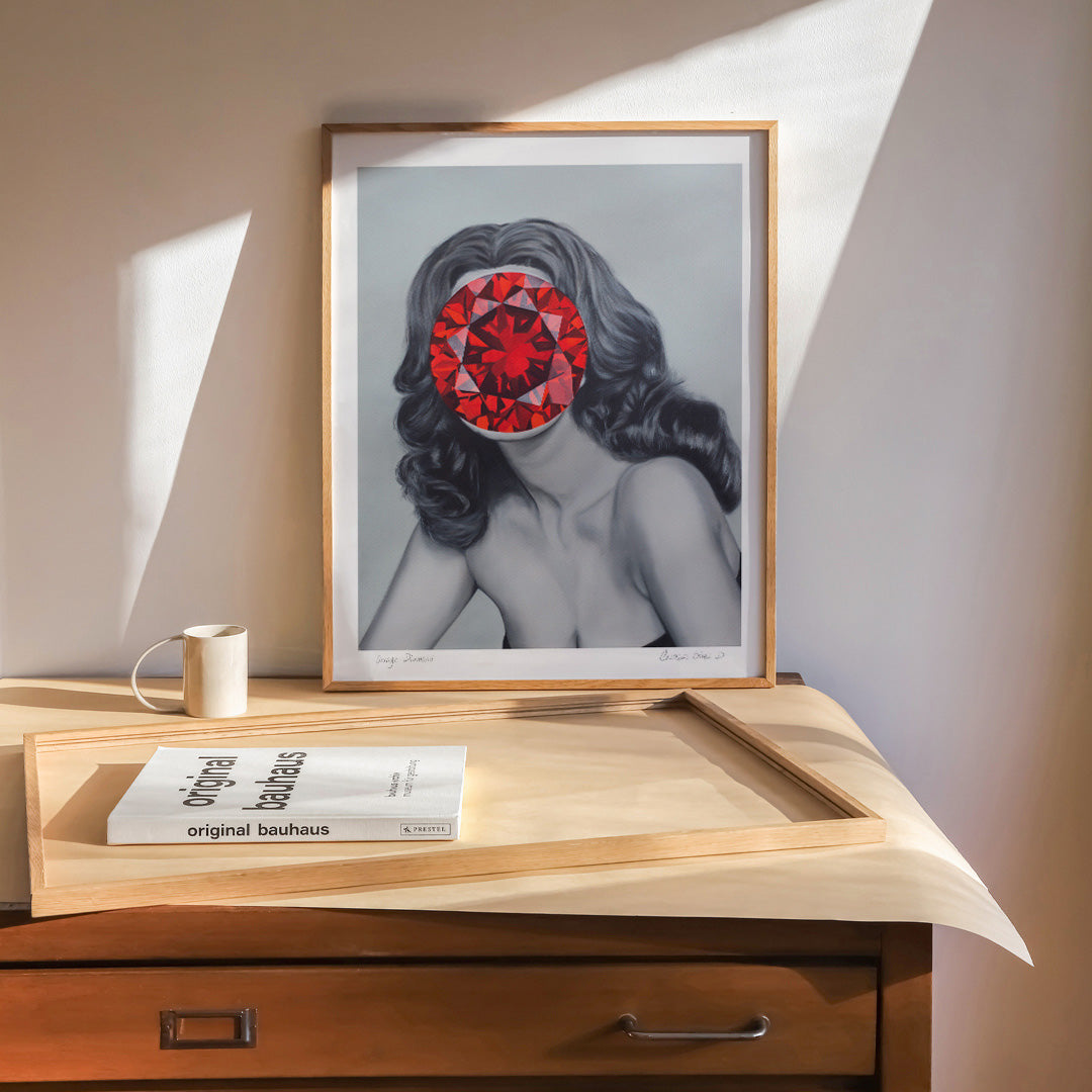 Modern portrait of a lady with a red jewel covering her face framed in a neutral interior space.