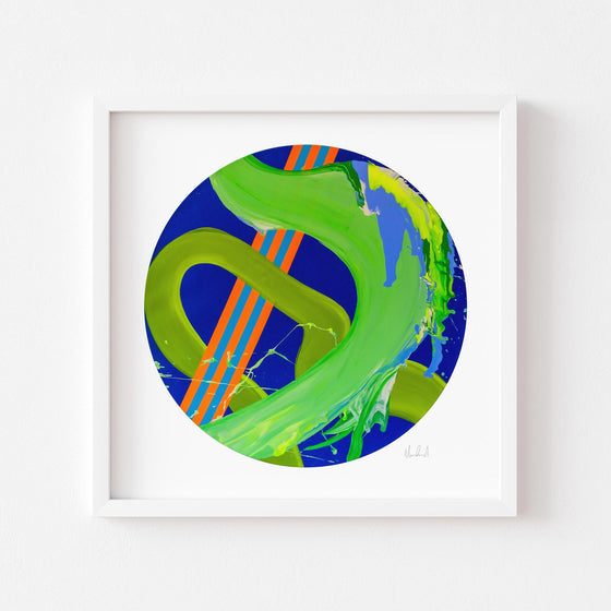 Green and blue circle art print in a white frame.