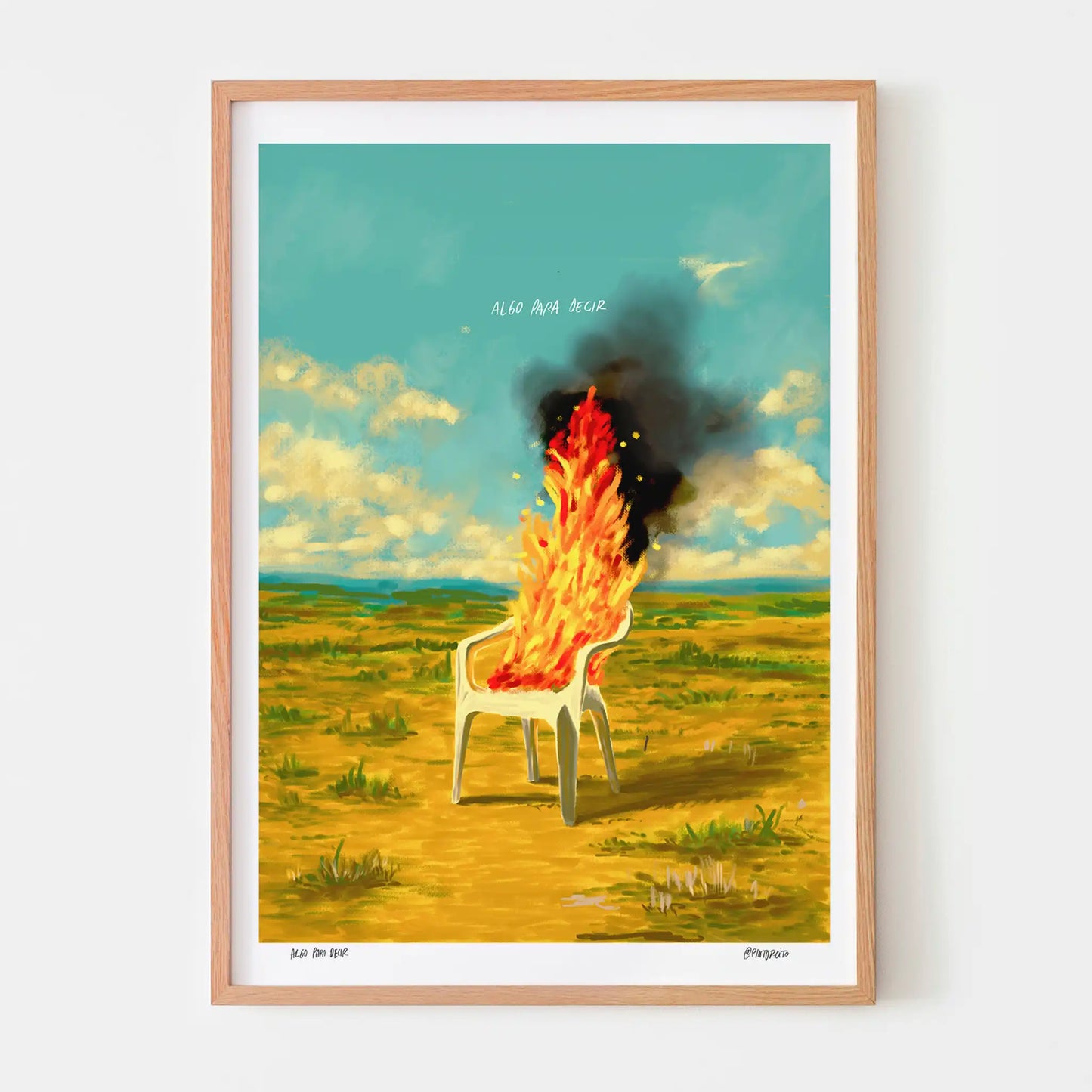 Framed artwork of a chair on fire in a field with a blue sky.