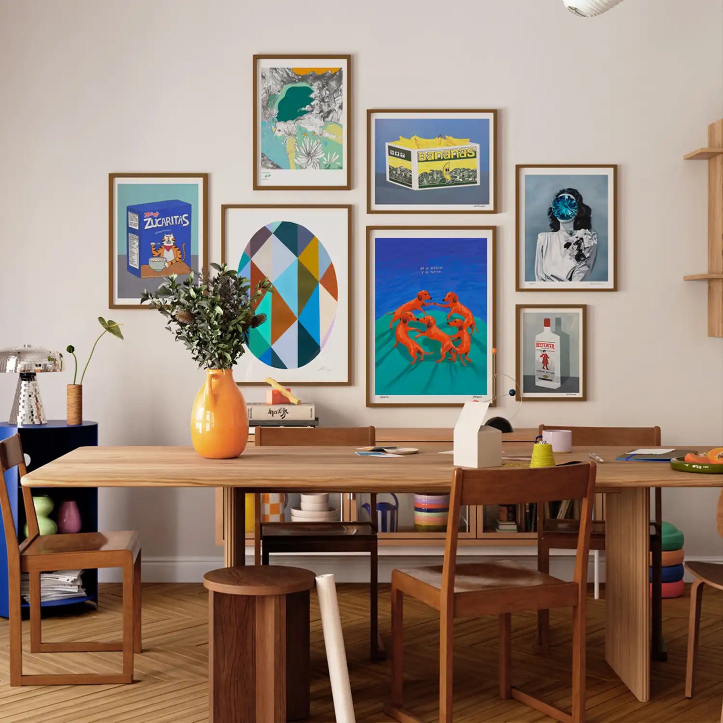 Dining room with wooden table and chairs, colorful wall art, and a vase on the table.