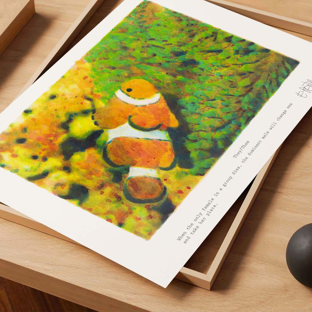 
                  
                    Unframed wall art print of a clownfish on a desk in a neutral interior.
                  
                