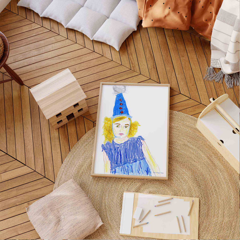 
                  
                    Wall art print of a child in a blue party outfit in an oak frame in a modern bedroom.
                  
                