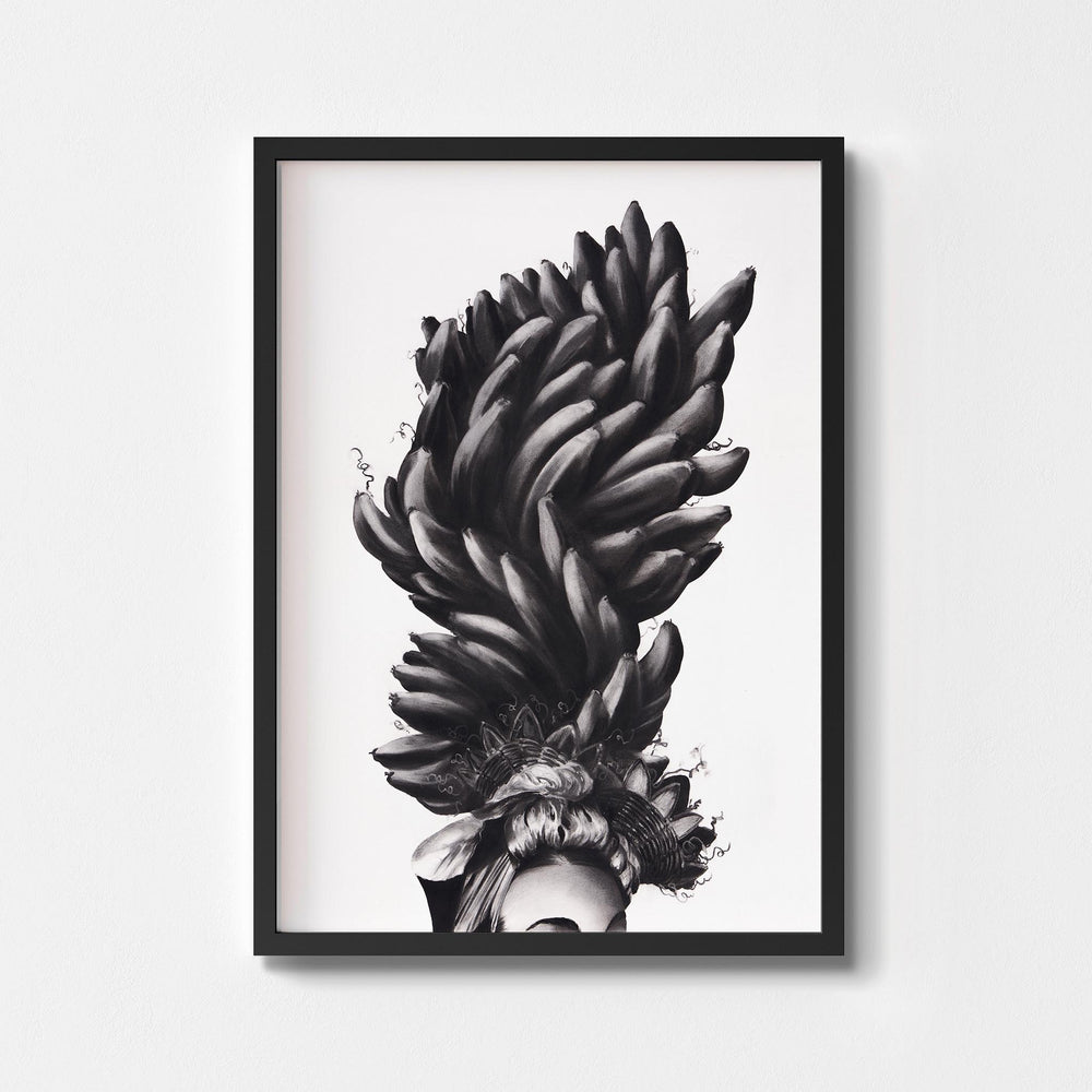 
                  
                    Black and white wall art print of a women wearing a banana headdress framed in black.
                  
                