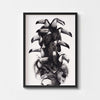 Black and white wall art print of a women wearing a toucan headdress framed in black. 