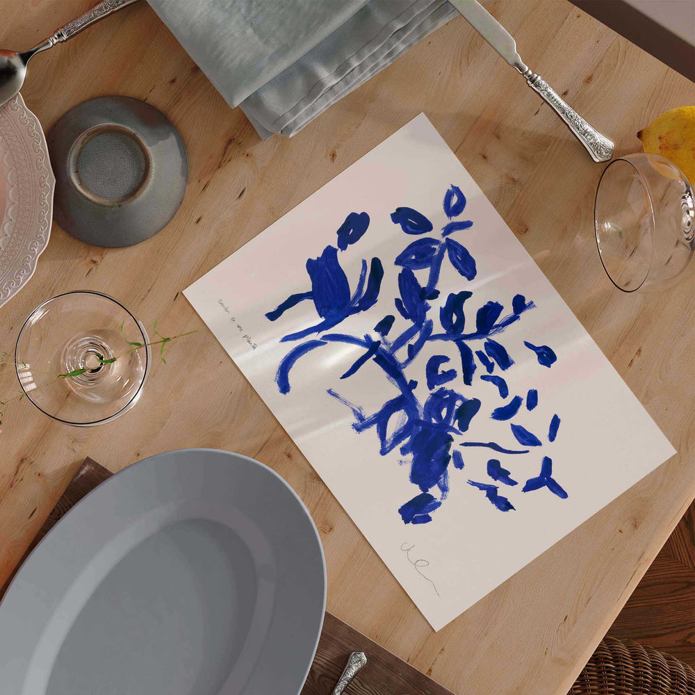 
                  
                    Unframed blue and white art wall print on a modern kitchen table.
                  
                