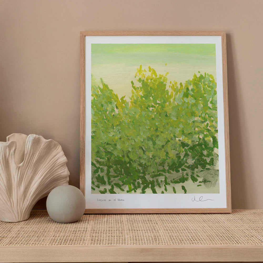 
                  
                    Framed green botanical print in a neutral living space.
                  
                