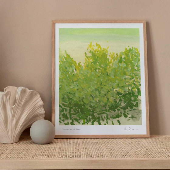 Framed green botanical print in a neutral living space.