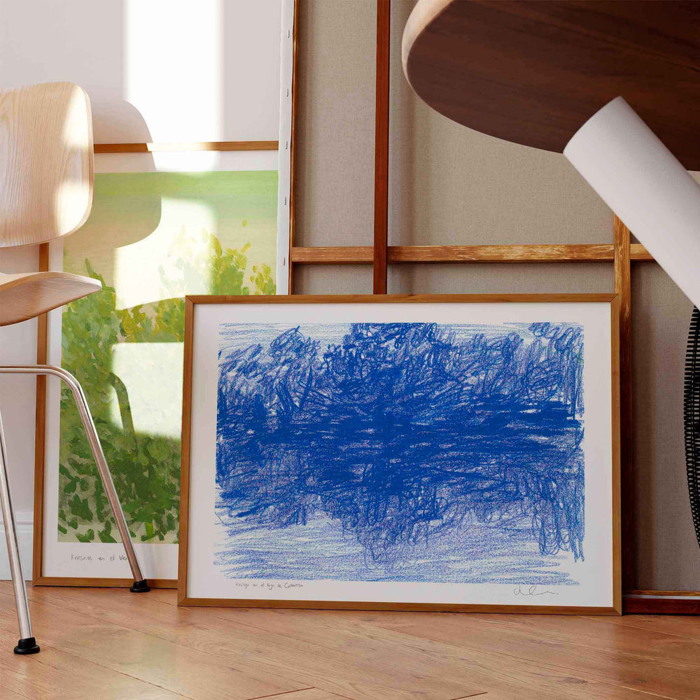 
                  
                    Framed blue landscape art print in a modern home interior.
                  
                