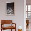 Framed monochrome fine art print of a cloud in a neutral modern interior.