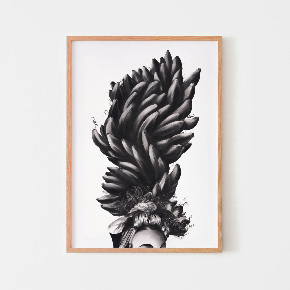 
                  
                    Monochrome wall art poster of a women in a banana headdress framed in oak.
                  
                