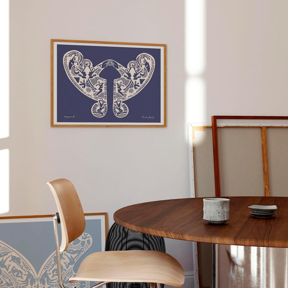 Dark blue art wall print with female figures framed in a modern dining room.