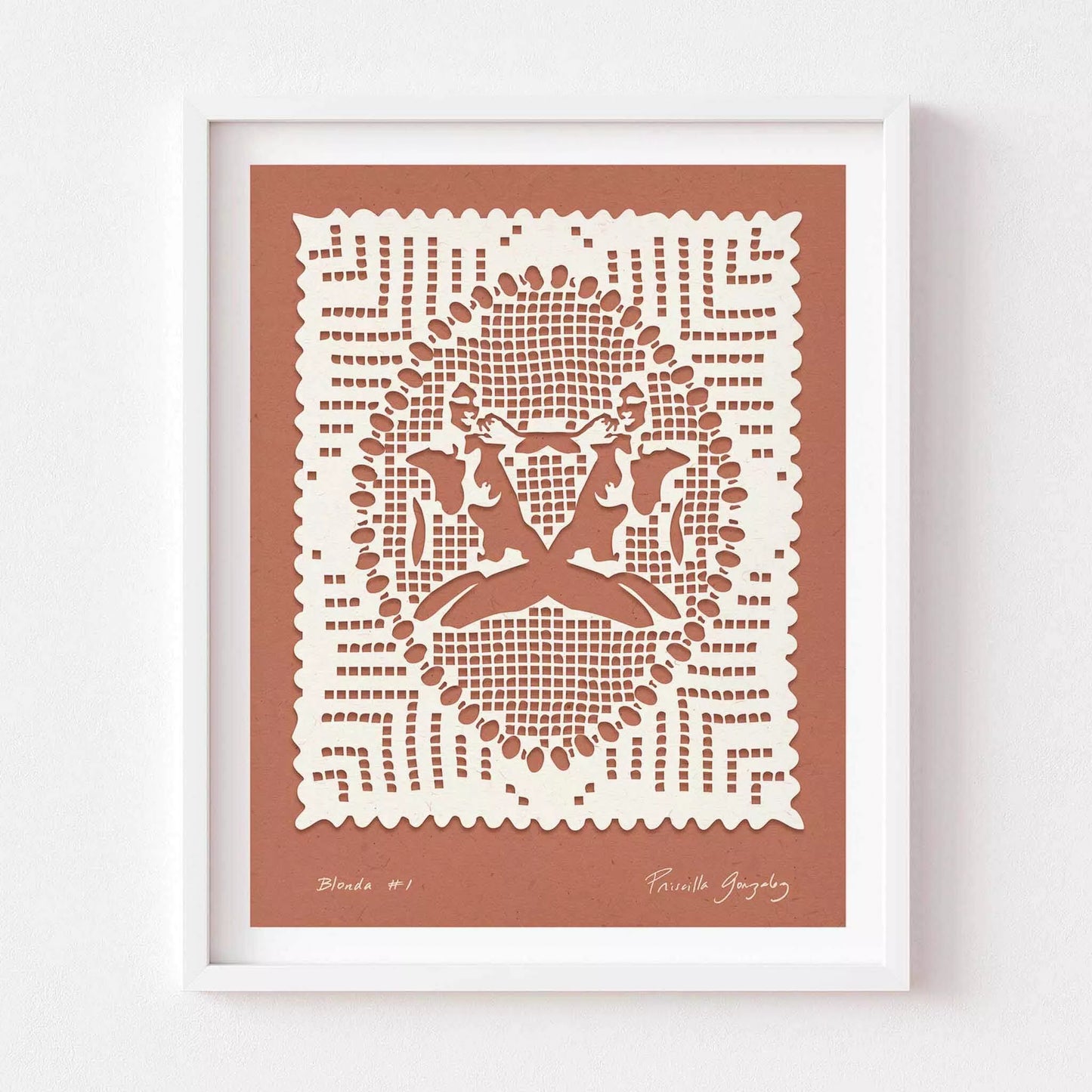 Framed papercut art with intricate design on a dark pink background