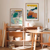 Two framed art prints of colourful landscapes in a modern living space.