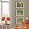 Set of three framed art prints of animals in a modern living room.