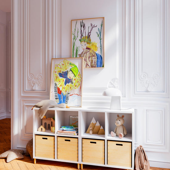 Pair of art print portraits of children in a neutral modern bedroom.