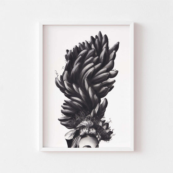 Black and white wall art print of a women wearing a banana headdress framed in white.