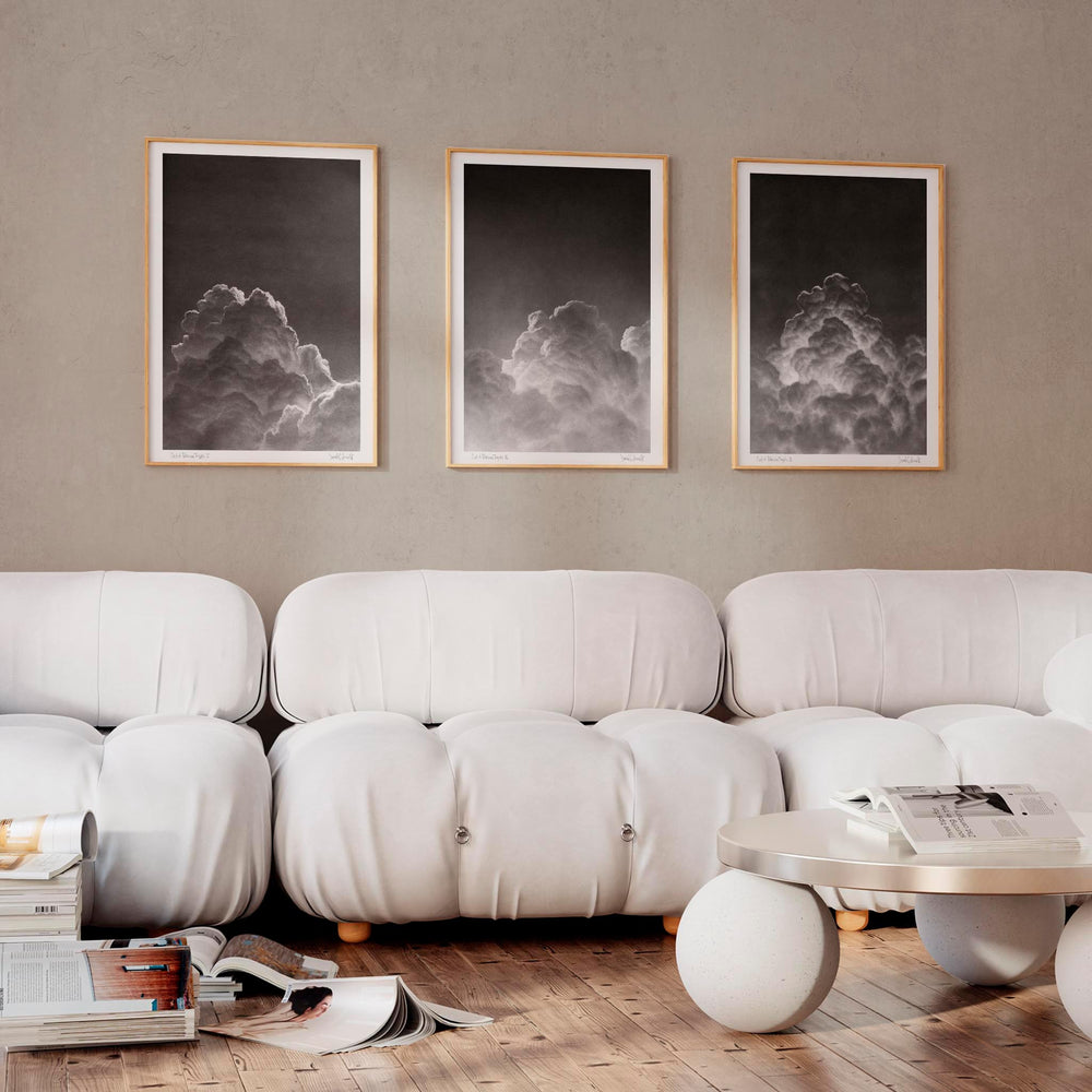 
                  
                    Set of three monochrome wall art prints of clouds in a neutral living room.
                  
                