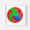 Circular red art print in a white frame.