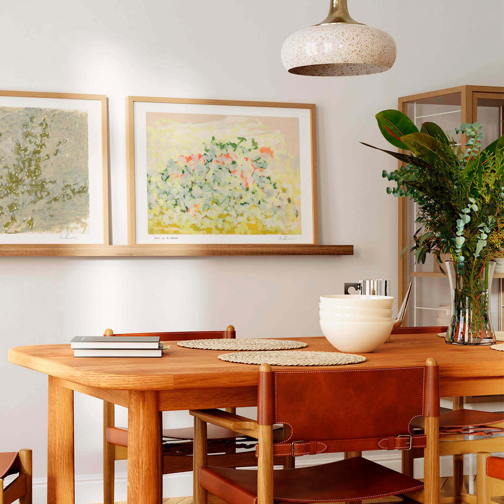 
                  
                    Pair of large neutral wall art prints in a modern dining room.
                  
                