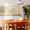 Pair of large neutral wall art prints in a modern dining room.