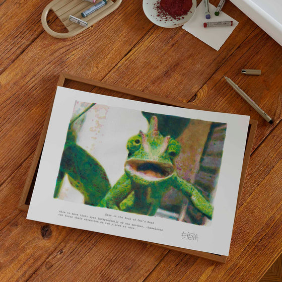 Unframed chameleon wall art print in a modern home office.