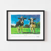 Contemporary wall art print of two cows framed in black.